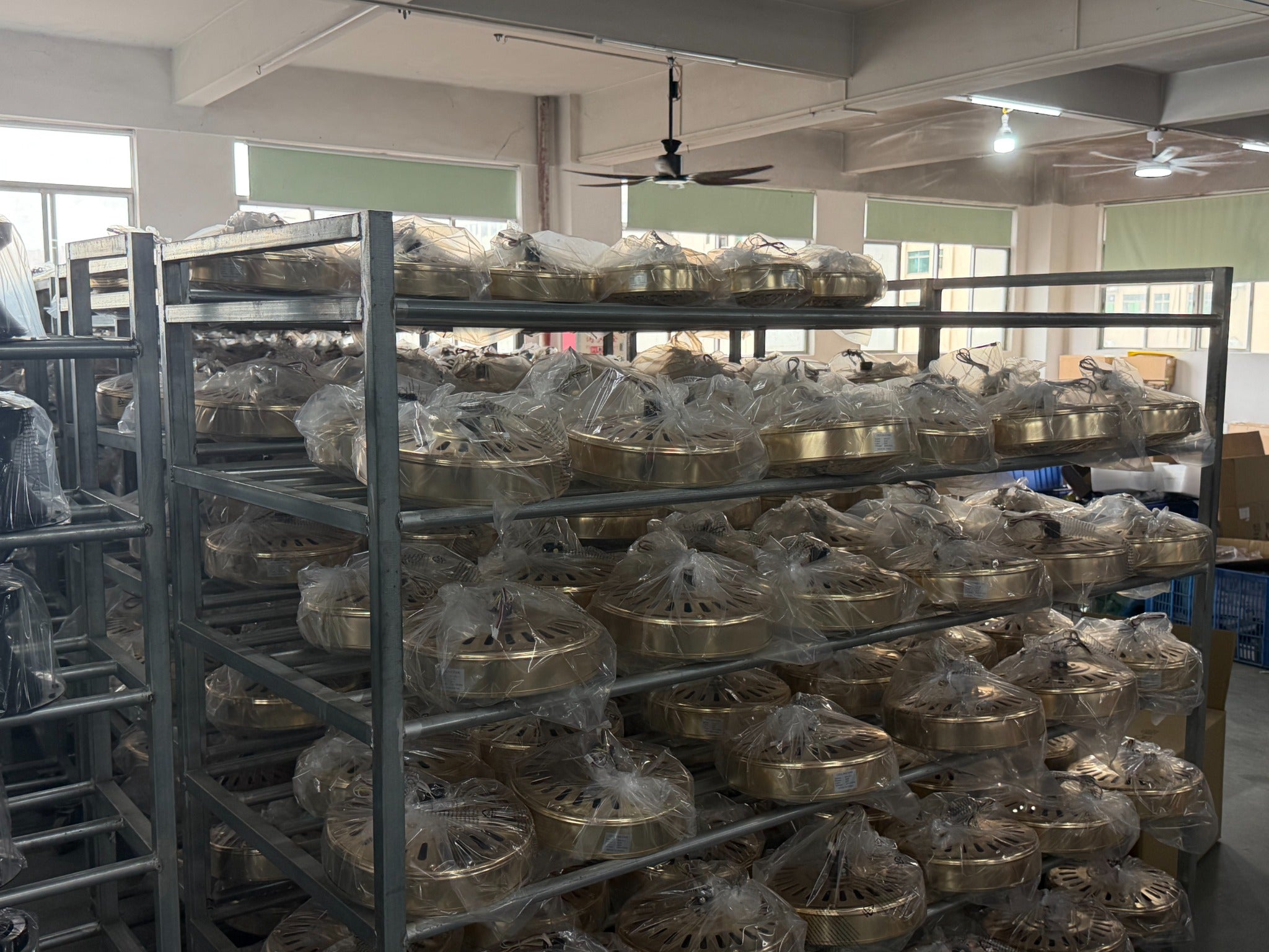 Shelves of individually bagged fan components in our factory