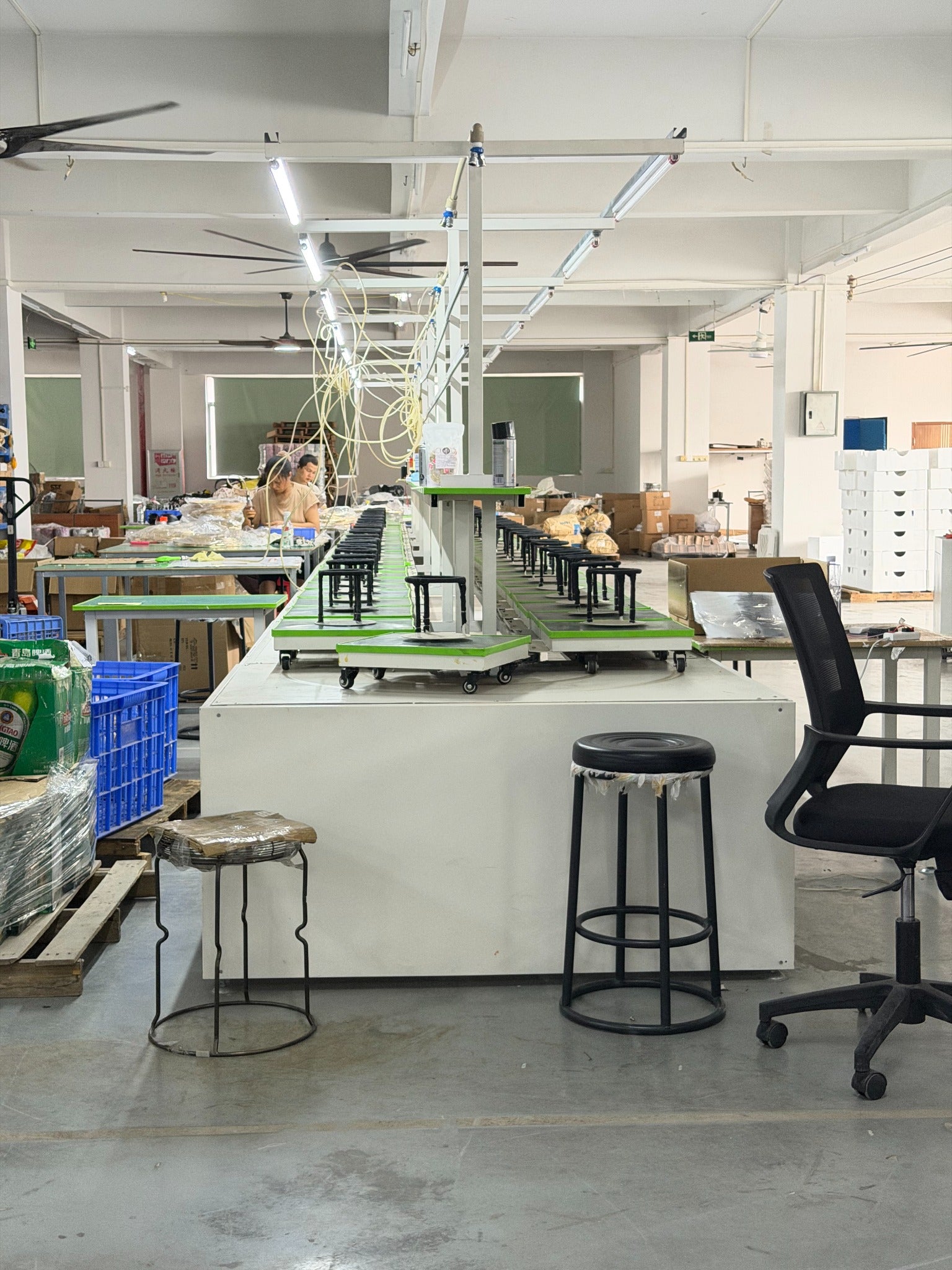 A photograph from our Zhongshan factory, with people working at the assembly benches